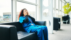 Exhausted nurse seated on lobby couch