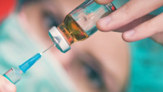 A vaccination dose being drawn from a bottle
