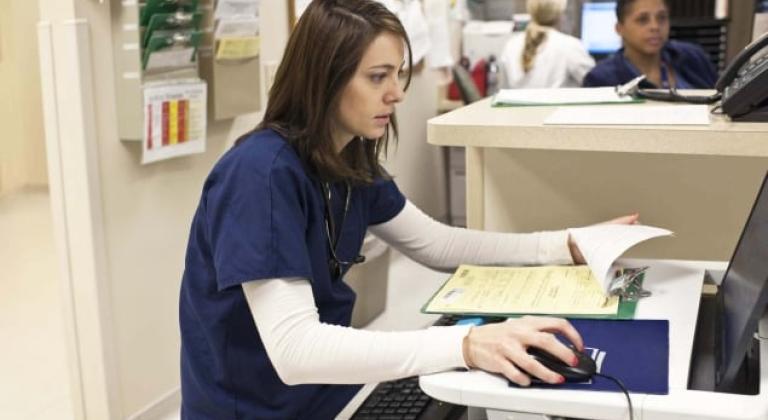 A nurse entering data into a computer