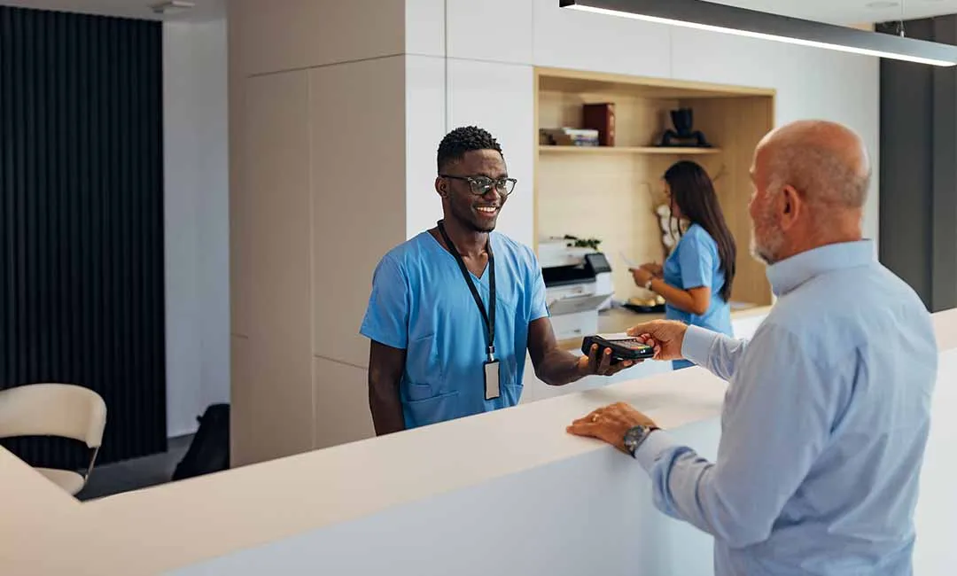 Person paying healthcare worker with credit card Person paying healthcare worker with credit card