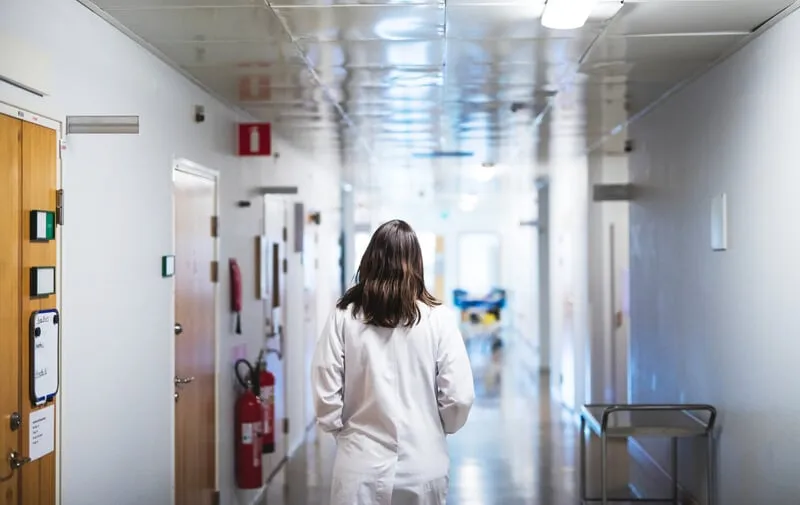 Nurse walking down corridor Nurse walking down corridor