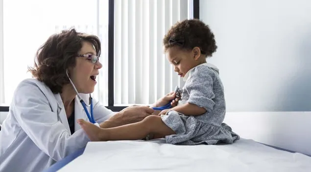 Doctor interacting with pediatric patient Doctor interacting with pediatric patient