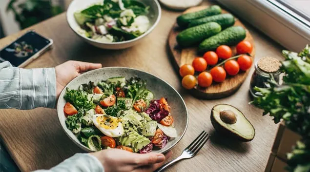 Hands holding a plate of healthy foods Hands holding a plate of healthy foods