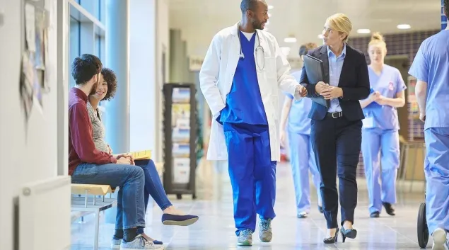 Clinicians walking down a hospital corridor