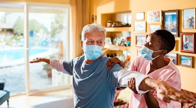 Physical therapist working with senior in a home setting