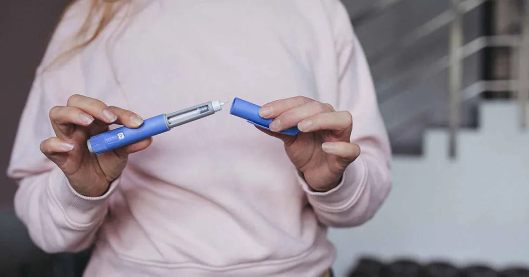 Person holding injectable drug dispenser