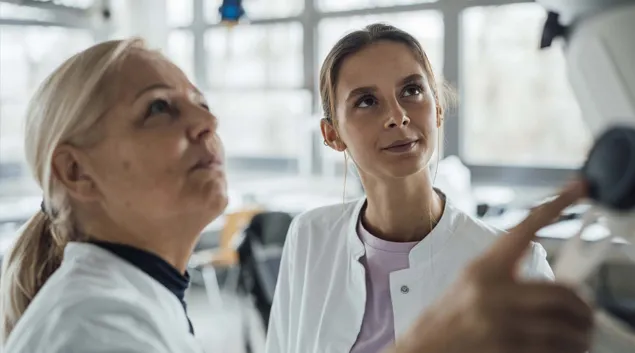 Clinicians consulting an artificial intelligence display