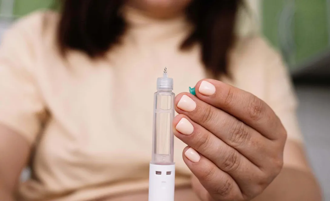 A woman holds an injectable medicine