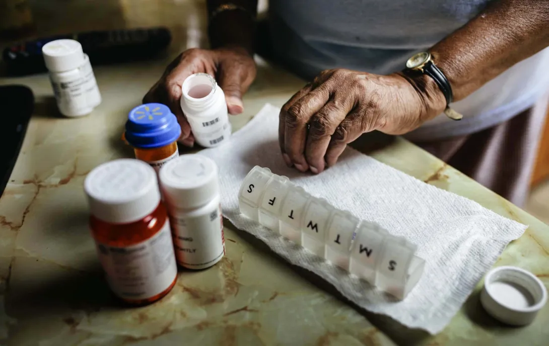 Senior woman sorting drugs