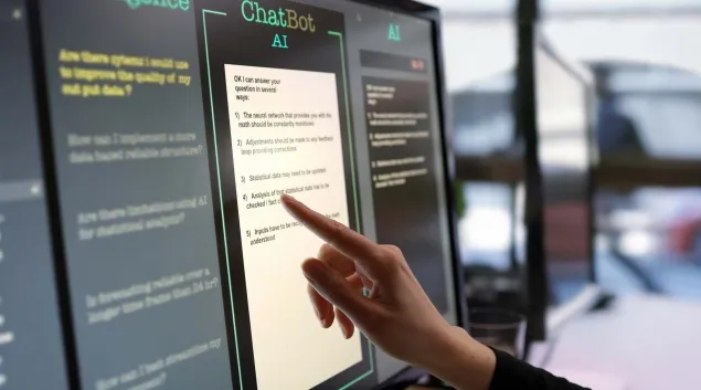 Hand pointing to an artificial intelligence display