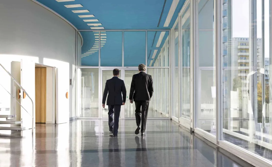 Business people walking in hospital corridor