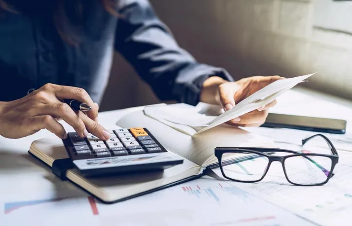Person at desk working a calculator