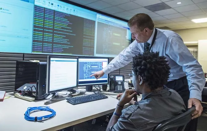 Two people in a control room