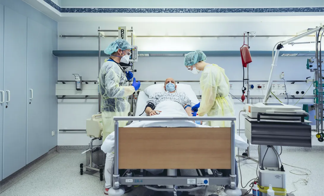 Healthcare professionals and patient in hospital bed