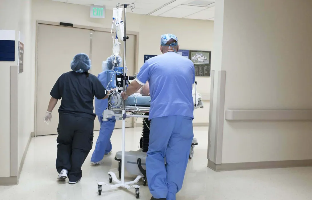 Hospital staff wheeling a patient