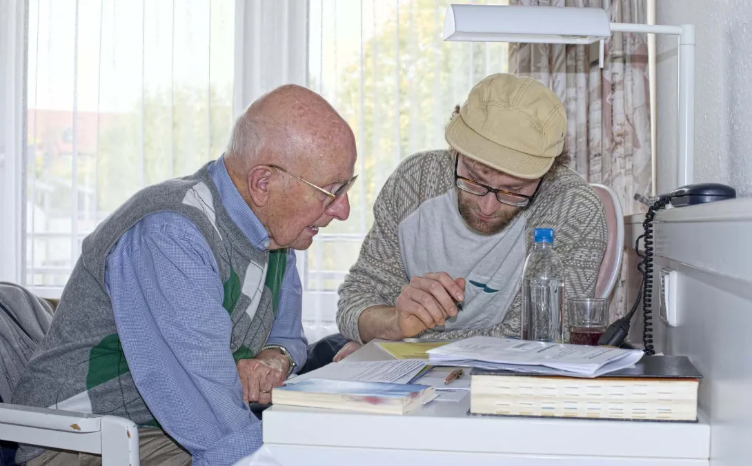 Two people go over insurance forms