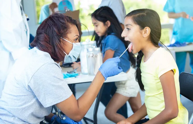 Clinician helping a child at a clinic.