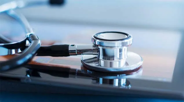 A stethoscope rests on a tablet.