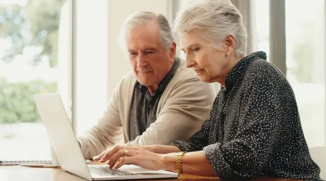 Senior couple sorting through medical bills
