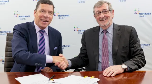 From left, John M. Murphy, MD, president and CEO of Nuvance Health, shakes hands with Northwell president and CEO Michael Dowling at a signing ceremony.