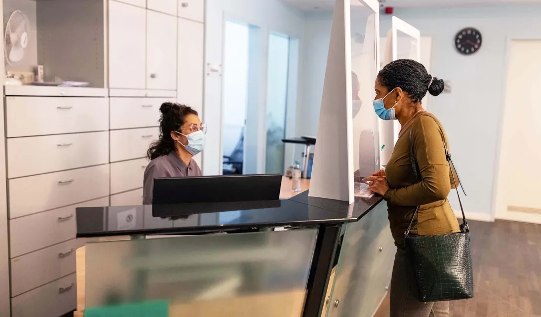 Patient at reception desk