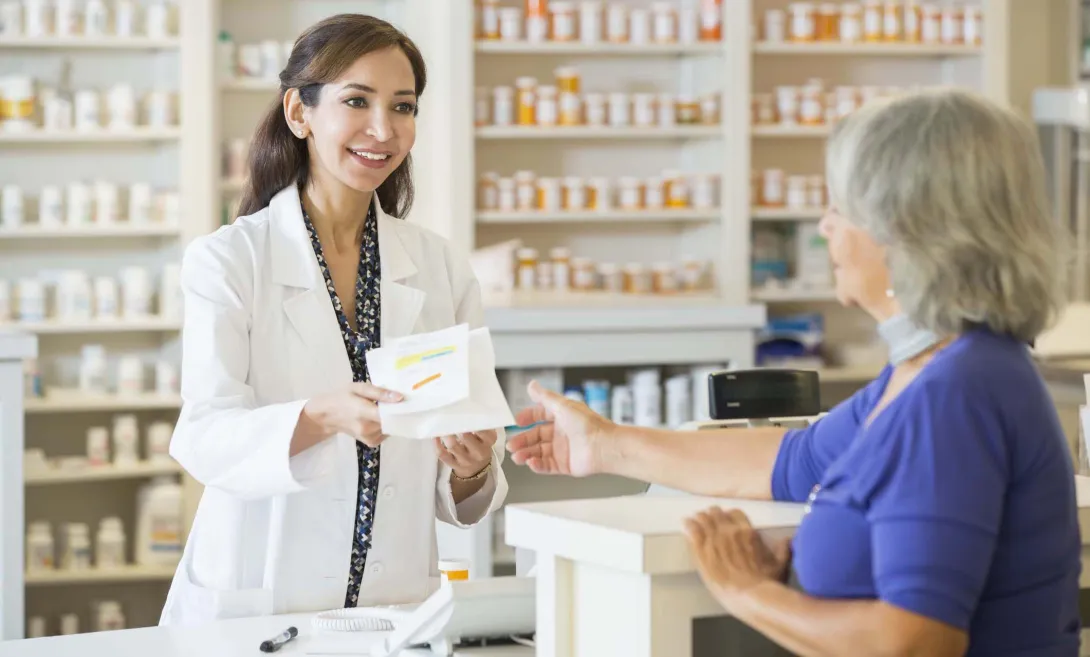 Pharmacist and buyer at counter