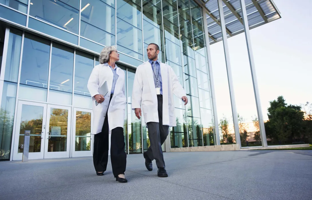 Two medical professionals exit a hospital. Photo: Peter Griffith/Getty Images