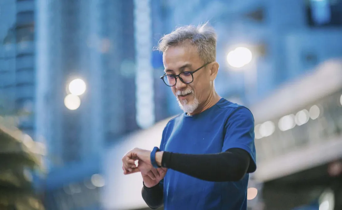 Person outside looking at fitness band