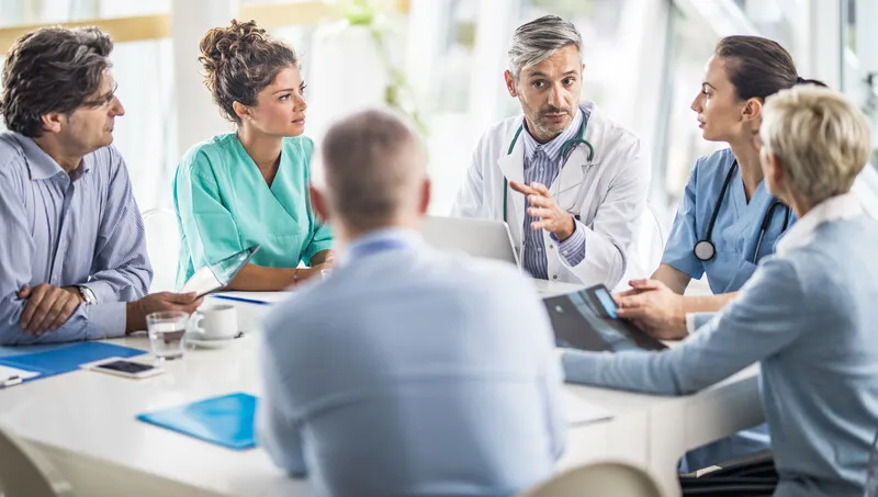 Health professionals meeting at a conference room table