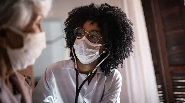 Doctor examines patient in office