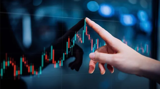 Finger pointing to graph line on screen