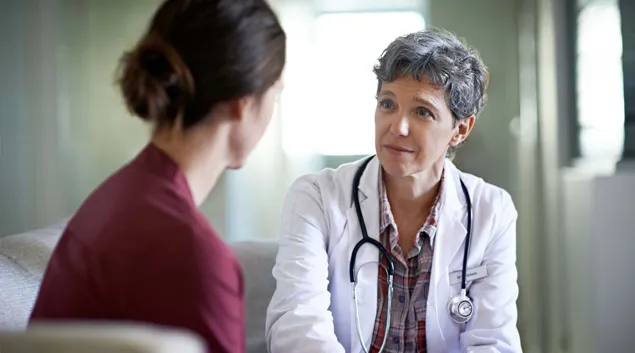 Doctor with patient in exam room