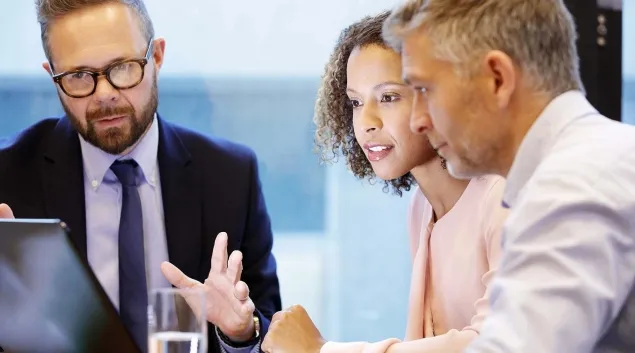 Business meeting with three at a table