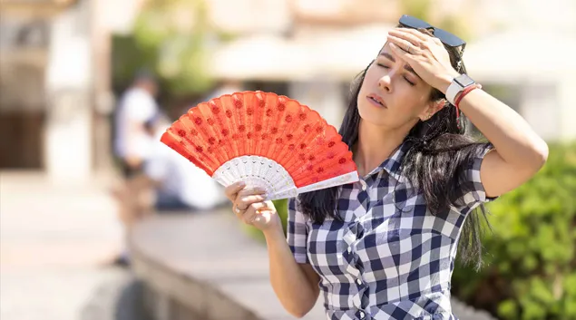Woman fanning herself in the heat