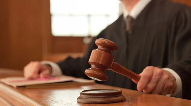 Judge in courtroom with gavel