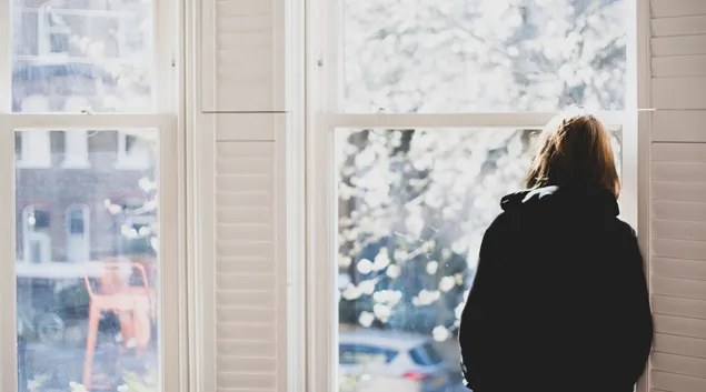 person looking out a window
