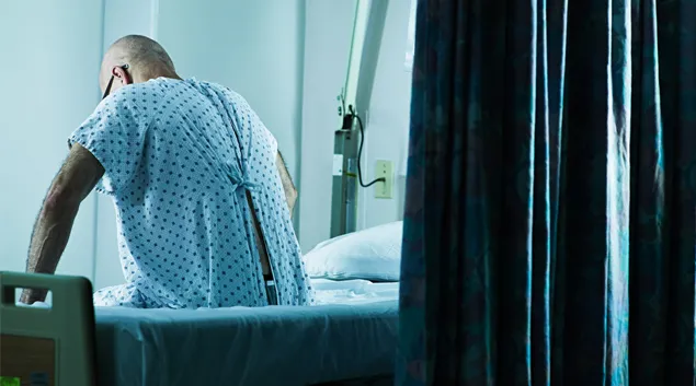 Person sits on hospital bed