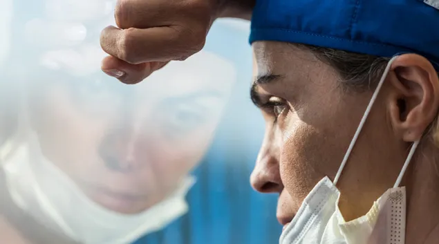 Medical professional stares out window
