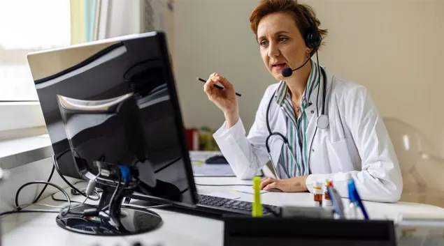 Healthcare professional at a screen